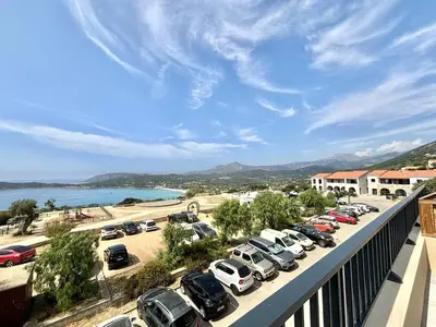 a view of a parking lot with cars parked at Appartement Cargèse Théâtre de Verdure in Cargèse