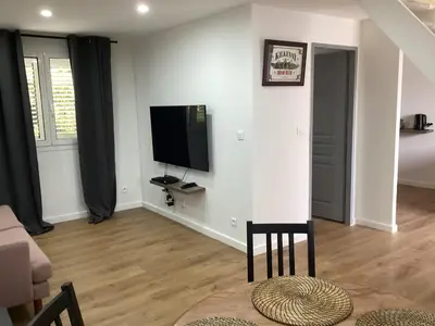 a living room with a flat screen tv on the wall at Saleccia in Santa-Lucia-di-Moriani