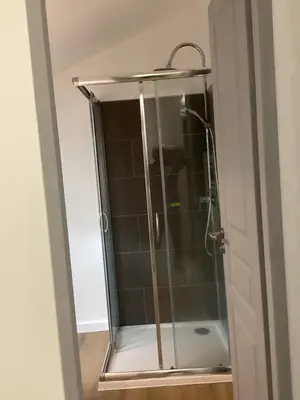 a shower with a glass door in a bathroom at Saleccia in Santa-Lucia-di-Moriani