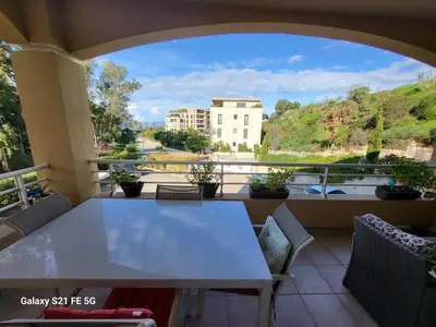 a table and chairs on a balcony with a view at T3 Vue mer bord de mer in Albitreccia