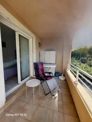 a chair sitting on a balcony with a table at T3 Vue mer bord de mer in Albitreccia