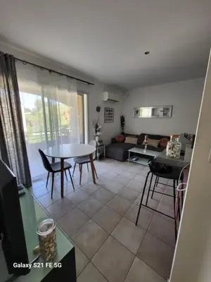 a living room with a table and a couch at T3 Vue mer bord de mer in Albitreccia