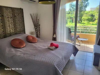 a bedroom with a bed with two stuffed animals on it at T3 Vue mer bord de mer in Albitreccia