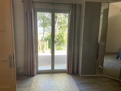 an empty room with a sliding glass door at Jolie maison familiale au cœur des vignes in Sartène
