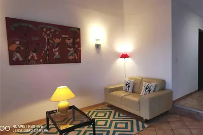 a living room with a couch and a table at Magique Creek, piscine naturelle dans les rochers in Zonza