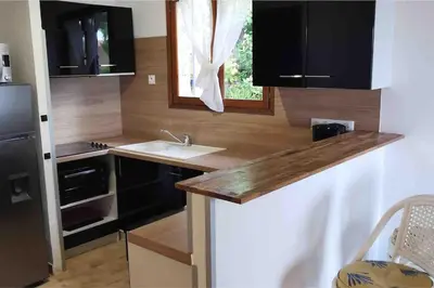 a small kitchen with a sink and a window at Magique Creek, piscine naturelle dans les rochers in Zonza