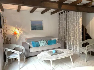 a living room with a couch and chairs and a table at Mini-villa à 1 minute de la plage de Santa Giulia in Porto-Vecchio