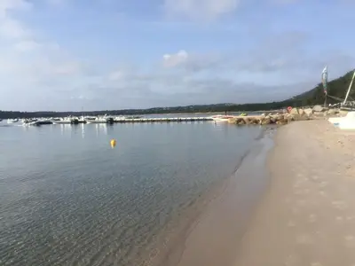 a beach with a group of boats in the water at Mini villa a 300m de la plage in Zonza