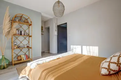 a bedroom with a large bed and a book shelf at A Stalla - Maison pieds dans l'eau à Lucciana in Lucciana