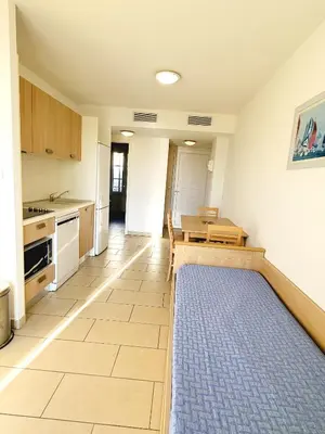 a kitchen with a table and a dining room at 4-6 couchages vue mer et port de Solenzara Corse in Sari Solenzara