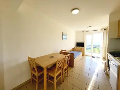 a kitchen and dining room with a table and chairs at 4-6 couchages vue mer et port de Solenzara Corse in Sari Solenzara