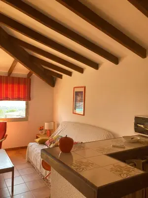 a living room with a bed and a table at Appartement Marina di santa giulia in Porto-Vecchio