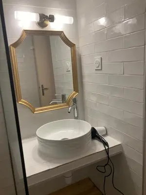 a bathroom with a white sink and a mirror at Appartement Marina di santa giulia in Porto-Vecchio