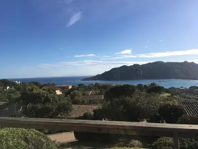 a view of a body of water with a mountain at Appartement Marina di santa giulia in Porto-Vecchio