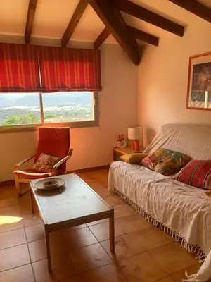 a bedroom with a bed and a chair and a table at Appartement Marina di santa giulia in Porto-Vecchio