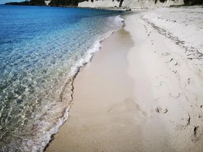 an aerial view of the shoreline of a beach at Auberge de Cannedda in Sari Solenzara