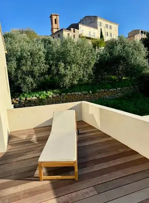 a bench sitting on top of a wooden deck at Villa Giuliana Paisible & spacieuse AREGNO in Aregno
