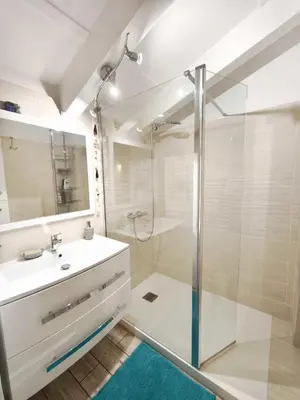 a bathroom with a glass shower and a sink at Bright apartment 3 minutes from the beach in Ajaccio