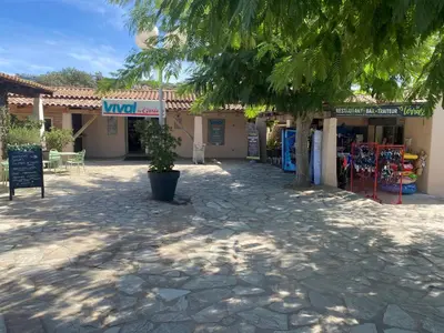 a building with a sign in front of it at Mini villa en duplex vue mer à 500 m de la plage de Santa Giulia in Porto-Vecchio