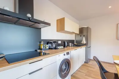 a kitchen with a washer and dryer in a room at La Casa Di Castagni - Climatisé avec terrasse in Oletta