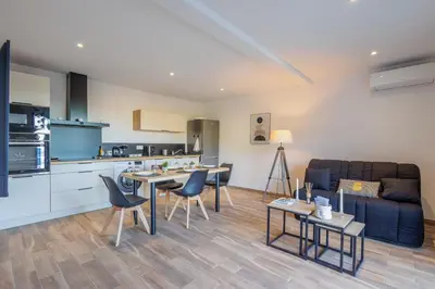 a kitchen and living room with a couch and a table at La Casa Di Castagni - Climatisé avec terrasse in Oletta