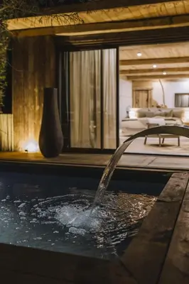 a pool with a water fountain in a hotel room at Lagnonu in Verghia