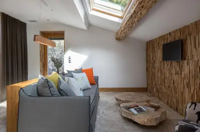 a living room with a gray couch and a table at Dominique Colonna in Corte