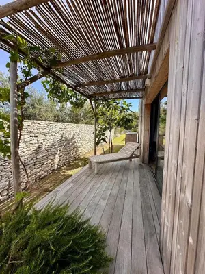 a wooden deck with a bench on a building at Villa Dina - Douceur et calme in Bonifacio