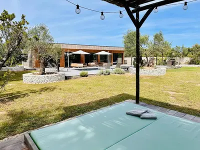 a backyard with a pool and a house at Villa Dina - Douceur et calme in Bonifacio