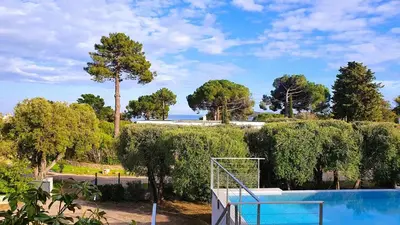 a swimming pool with a fence and a goal at Villa Stella Diana, 12 pers, 100 m plage in Pinarellu