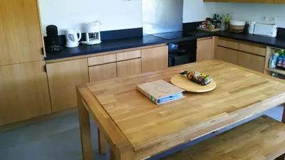 a wooden table in a kitchen with a plate on it at Villa Stella Diana, 12 pers, 100 m plage in Pinarellu
