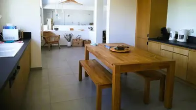 a kitchen with a wooden table and a dining room at Villa Stella Diana, 12 pers, 100 m plage in Pinarellu