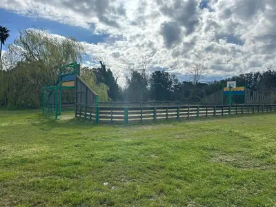 a park with a fence and a basketball hoop at T3 résidence privée proche plage et piscine in Poggio-Mezzana