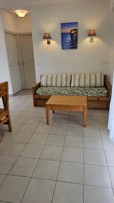 a living room with a couch and a coffee table at T3 résidence privée proche plage et piscine in Poggio-Mezzana