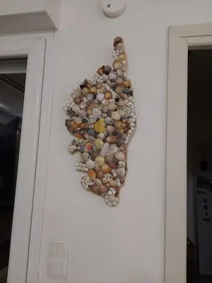 a wall with a bunch of rocks on the wall at T3 résidence privée proche plage et piscine in Poggio-Mezzana