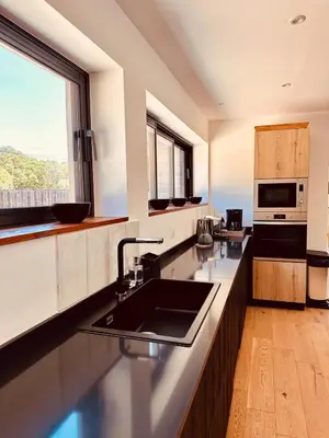 a large kitchen with a sink and a microwave at Villa Gioia- Charme et sérénité in Bonifacio