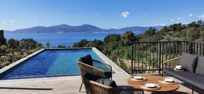 a patio with a pool and a table and chairs at Casa PETRA et FIORI, une bergerie en pierres authentiques toute équipée - 4 personnes in Pietrosella