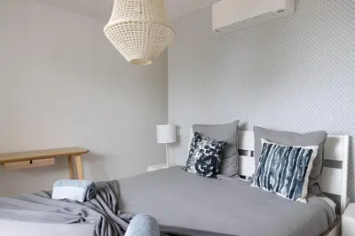 a bedroom with a bed with pillows on it at Villa Maquis, Vue mer, élégante maison au calme, 80m2, 4 personnes in Pietrosella