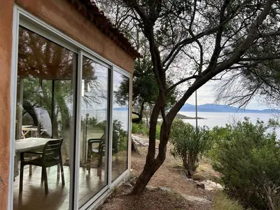 a room with a table and a view of the water at Résidence Capizzolu in Cargèse