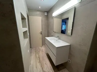 a bathroom with a white sink and a mirror at Résidence Capizzolu in Cargèse