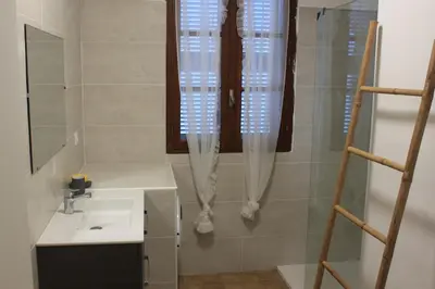 a bathroom with a sink and a window at Villa climatisée, superbe vue mer in Ventiseri