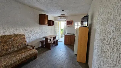 a kitchen with a couch and a table in a room at LA PALGE Le Centuri in Linguizzetta