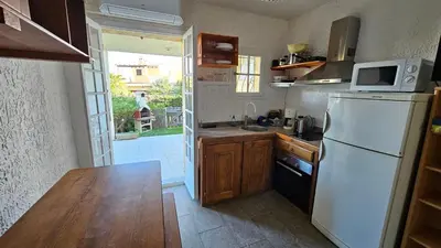 a kitchen with a white refrigerator and a sink at LA PALGE Le Centuri in Linguizzetta