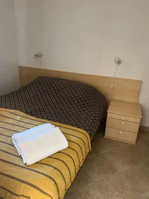 a bedroom with a bed with a white towel on it at Les jardins de la mer marine de Bravone in Linguizzetta
