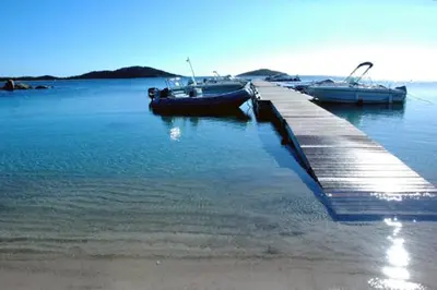 two boats are docked at a dock in the water at Porto Vecchio - Résidence RIVIERA - Villa Sogno in Lecci