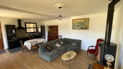 a living room with a couch and a table at Villa avec vue panoramique sur les montagnes in Corscia