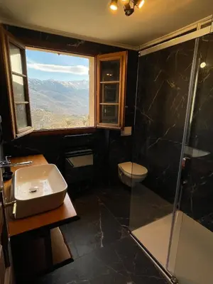 a bathroom with a shower and a sink and a window at Villa avec vue panoramique sur les montagnes in Corscia