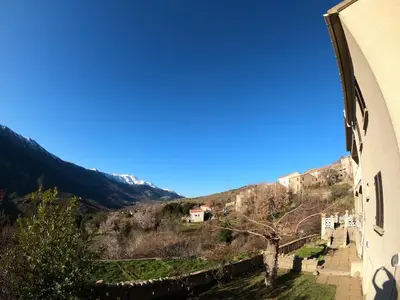 a view of the mountains from the side of a building at Villa avec vue panoramique sur les montagnes in Corscia
