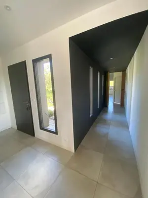 a hallway of a house with black walls and a window at Haut de Villa - Corsica in Lecci