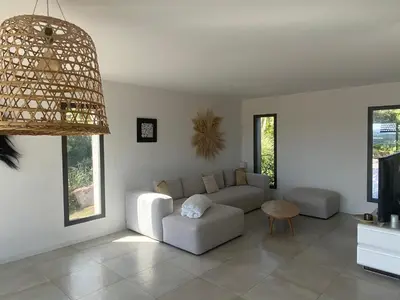 a living room with a couch and a table at Haut de Villa - Corsica in Lecci